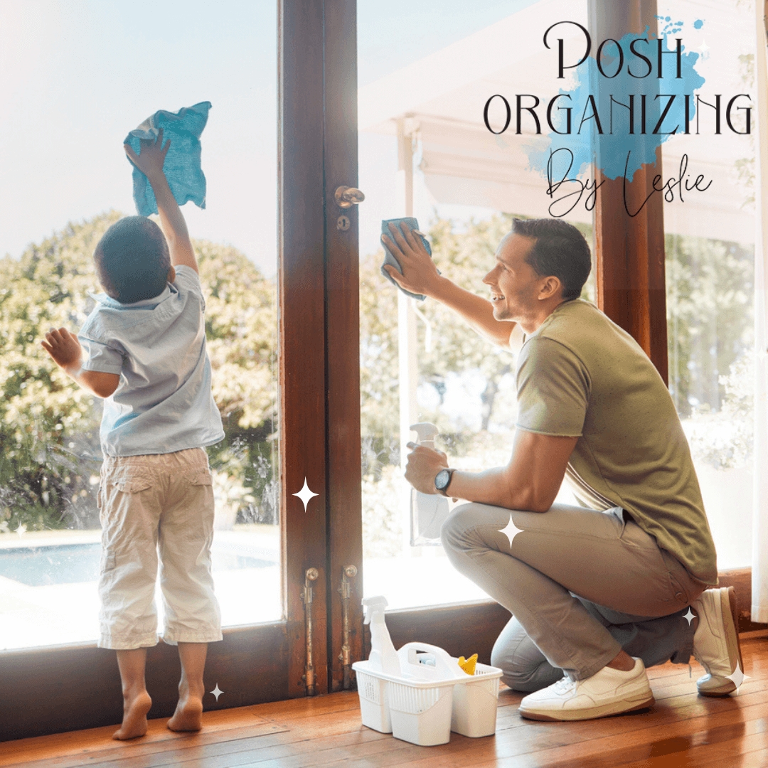 A little boy helping his father wipe the glass doors.